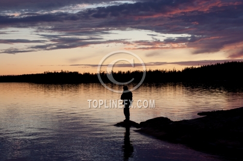 Fisherman silhouette on the beach at colorful sunset 05