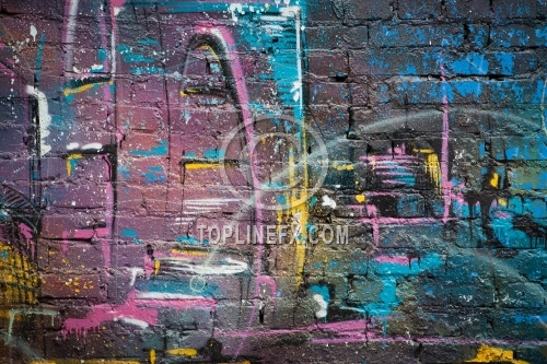 Grunge brick wall with gaffiti and colorful  paint